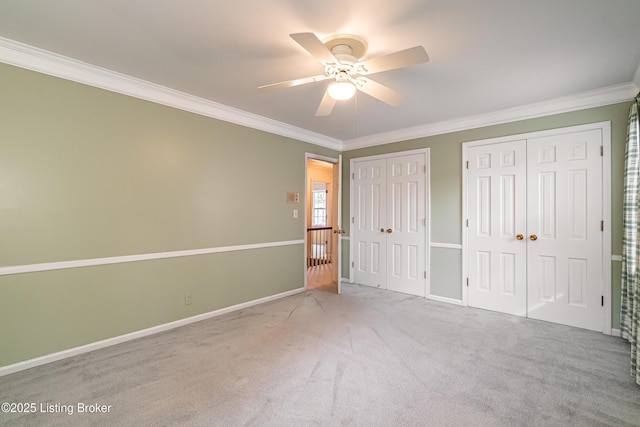 3920 Elfin Ave, Louisville, KY 40207 - unfurnished bedroom with multiple closets, crown molding, carpet floors, and ceiling fan