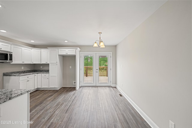 3020 Thorntree Ln, Lawrenceburg, KY 40342 - kitchen featuring stainless steel microwave, white cabinets, light stone counters, wood finished floors, and recessed lighting