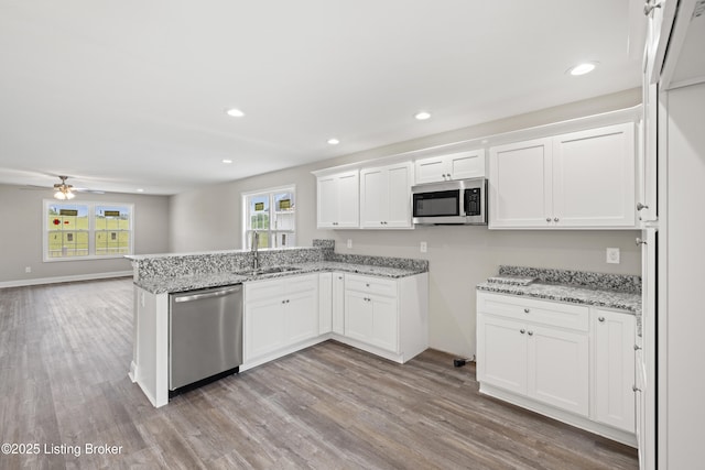 3020 Thorntree Ln, Lawrenceburg, KY 40342 - kitchen with appliances with stainless steel finishes, white cabinetry, wood finished floors, and recessed lighting