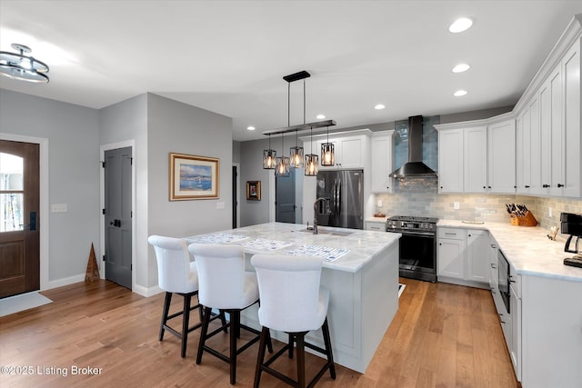 115 Christine Ct, Bardstown, KY 40004 - kitchen with wall chimney exhaust hood, appliances with stainless steel finishes, tasteful backsplash, a breakfast bar, and light wood-style floors
