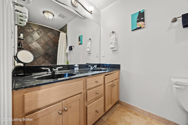 953 Baxter Ave Unit 101, Louisville, KY 40204 - full bathroom with double vanity, a shower with shower curtain, and tile patterned flooring