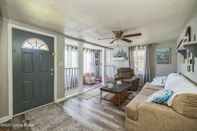 917 Scaffold Cane Rd, Berea, KY 40403 - living area featuring a textured ceiling, wood finished floors, plenty of natural light, and a ceiling fan
