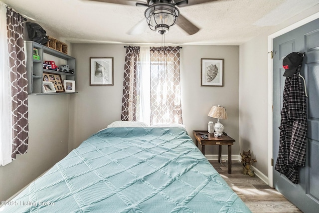 917 Scaffold Cane Rd, Berea, KY 40403 - bedroom with wood finished floors, a ceiling fan, and a textured ceiling