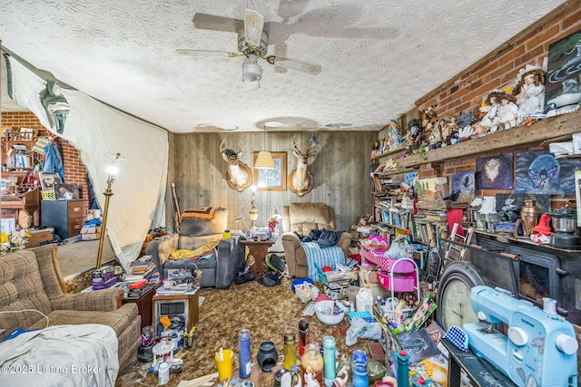 911 N Main St, Barbourville, KY 40906 - living area featuring ceiling fan, wooden walls, a textured ceiling, and brick wall