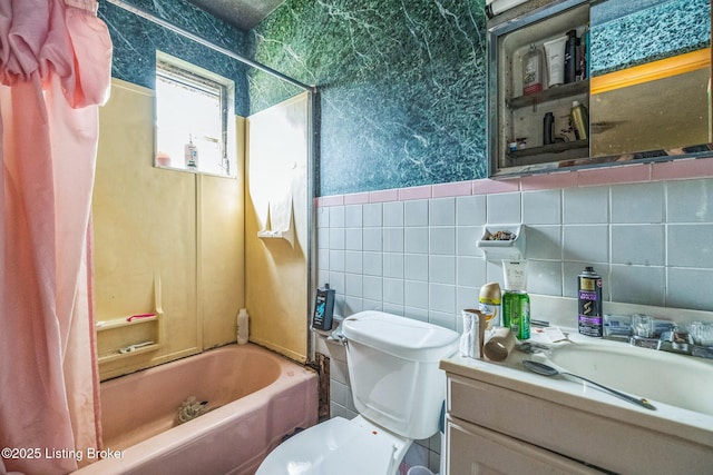 911 N Main St, Barbourville, KY 40906 - full bath featuring vanity, tile walls, wallpapered walls, and shower / bathtub combination with curtain