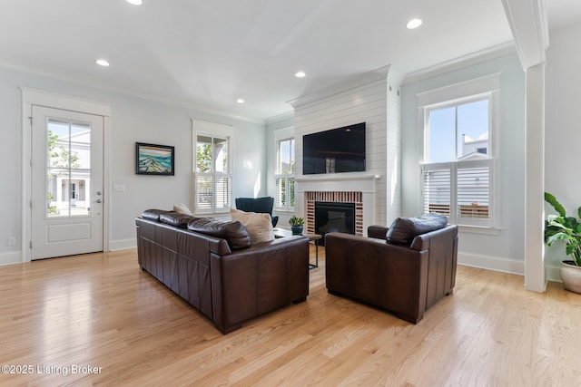 6113 St Bernadette Ave, Prospect, KY 40059 - living area featuring light wood-style floors, healthy amount of natural light, a brick fireplace, ornamental molding, and recessed lighting