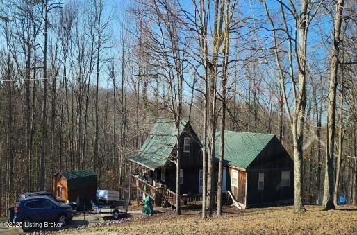 215 Bentley Cir, Wellington, KY 40387 - view of front facade with a porch and a wooded view