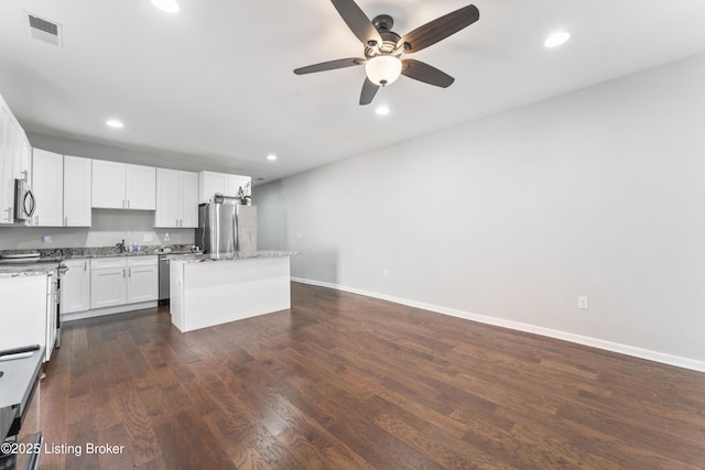930 York St, Newport, KY 41071 - kitchen with appliances with stainless steel finishes, a center island, ceiling fan, recessed lighting, and white cabinetry