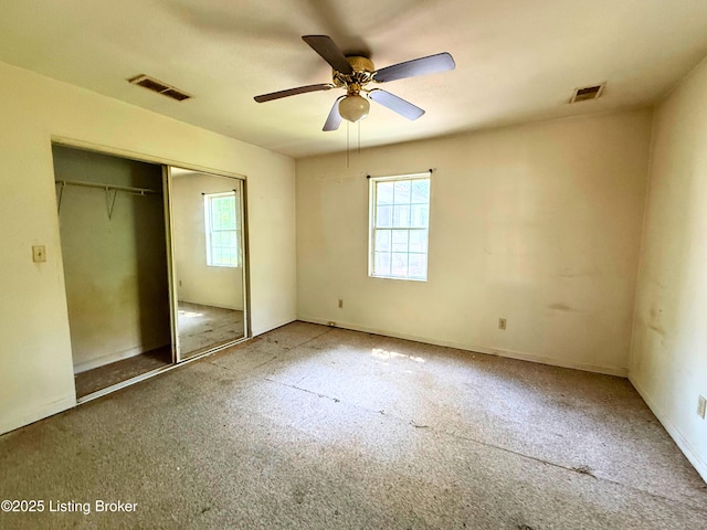 3809 Algonquin Pkwy, Louisville, KY 40211 - unfurnished bedroom featuring multiple windows, a closet, and carpet