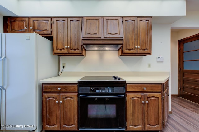 4401 Greenhaven Ln, Goshen, KY 40026 - kitchen featuring stove, freestanding refrigerator, dark wood-style floors, and light countertops