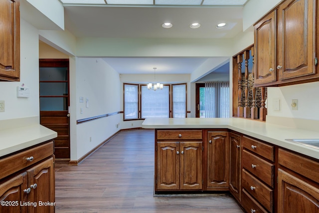 4401 Greenhaven Ln, Goshen, KY 40026 - kitchen with a chandelier, light countertops, a peninsula, dark wood-style floors, and recessed lighting