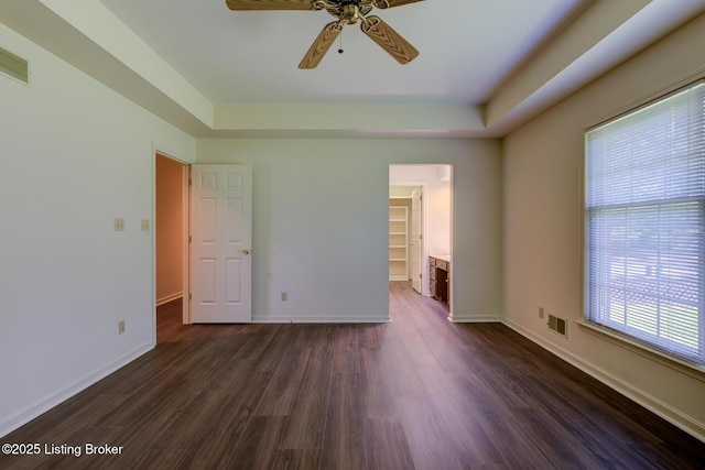 4401 Greenhaven Ln, Goshen, KY 40026 - unfurnished bedroom featuring a tray ceiling, a walk in closet, dark wood-style floors, and ceiling fan