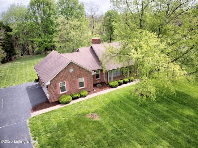 4401 Greenhaven Ln, Goshen, KY 40026 - view of front of home with a front lawn, a chimney, brick siding, and roof with shingles