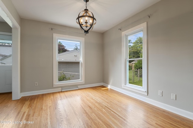 1005 Rosemary Dr, Louisville, KY 40213 - unfurnished dining area with healthy amount of natural light, a chandelier, and light wood-style flooring