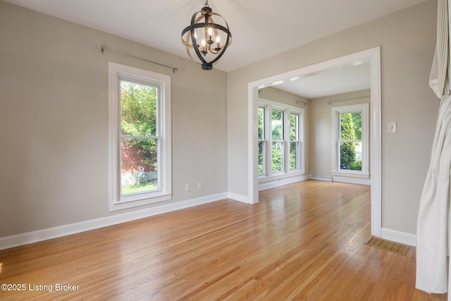 1005 Rosemary Dr, Louisville, KY 40213 - spare room featuring a chandelier, healthy amount of natural light, and light wood-style floors