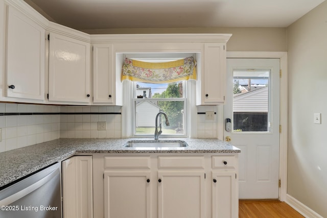 1005 Rosemary Dr, Louisville, KY 40213 - kitchen featuring dishwasher, light wood finished floors, decorative backsplash, and white cabinetry