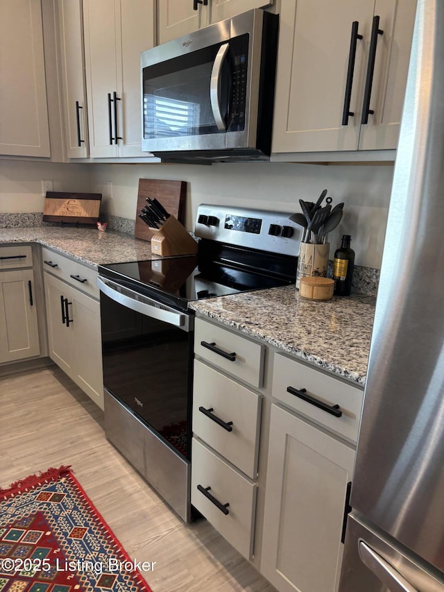 4021 White Pine Ln, La Grange, KY 40031 - kitchen with appliances with stainless steel finishes, light wood-style flooring, and light stone countertops