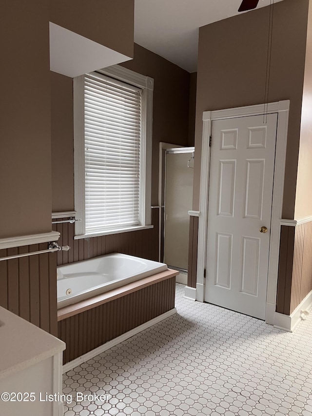 1308 S 2nd St, Louisville, KY 40208 - bathroom with a whirlpool tub, a shower stall, and a wainscoted wall