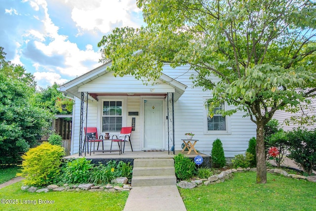 129 E Park Pl, Jeffersonville, IN 47130 - view of front of home with covered porch and a front lawn
