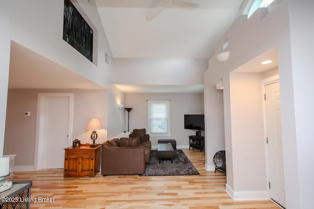129 E Park Pl, Jeffersonville, IN 47130 - living area featuring light wood-type flooring, a ceiling fan, and a towering ceiling