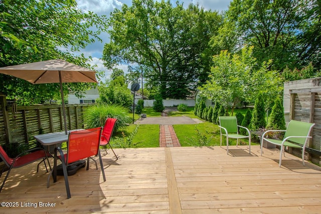 129 E Park Pl, Jeffersonville, IN 47130 - wooden deck with outdoor dining space and a fenced backyard