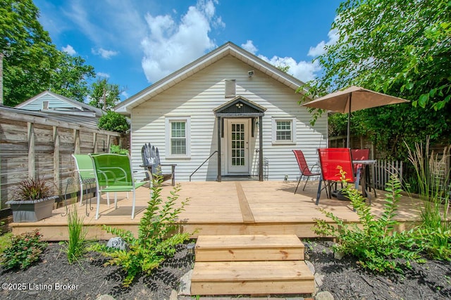 129 E Park Pl, Jeffersonville, IN 47130 - rear view of house featuring a wooden deck and outdoor dining space