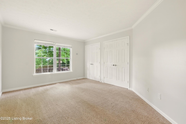 11411 Catalpa View Ct, Louisville, KY 40299 - unfurnished bedroom with two closets, crown molding, and carpet flooring