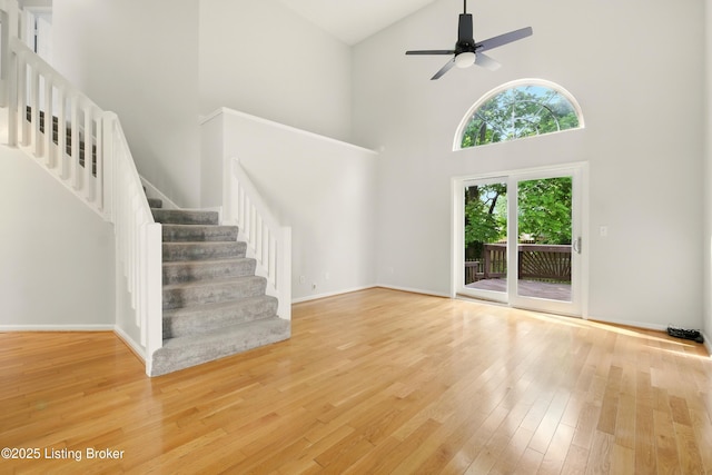11411 Catalpa View Ct, Louisville, KY 40299 - unfurnished living room featuring high vaulted ceiling, stairway, wood finished floors, and ceiling fan