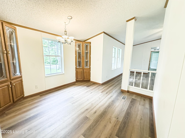 77 Old Ky 259th Rd, Mcdaniels, KY 40152 - unfurnished dining area with a chandelier, light wood-style flooring, ornamental molding, and a textured ceiling
