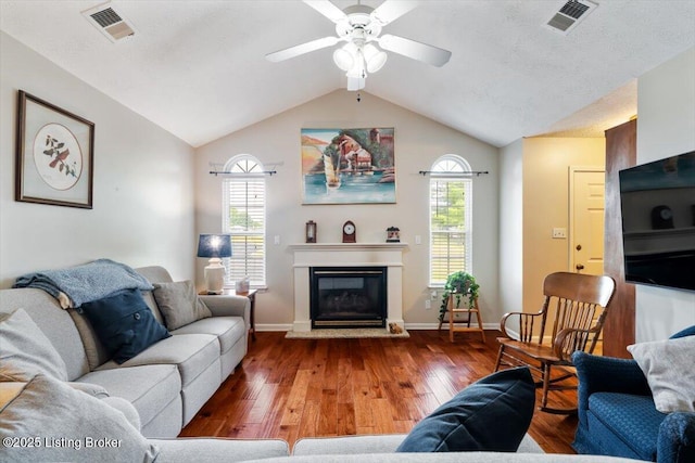 11300 Rdg Lake Dr, Louisville, KY 40272 - living area featuring wood finished floors, a ceiling fan, lofted ceiling, and a glass covered fireplace