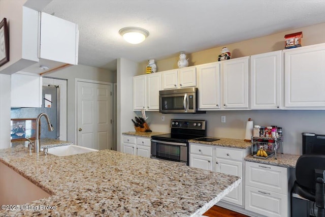 11300 Rdg Lake Dr, Louisville, KY 40272 - kitchen with stainless steel appliances, white cabinetry, and light stone counters