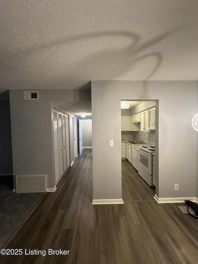 7070 Wildwood Cir Unit 154, Louisville, KY 40291 - kitchen featuring white electric range, dark wood-type flooring, white cabinets, and a textured ceiling