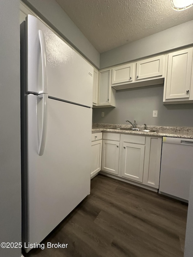 7070 Wildwood Cir Unit 154, Louisville, KY 40291 - kitchen featuring white appliances, a textured ceiling, dark wood-style floors, white cabinetry, and light stone counters