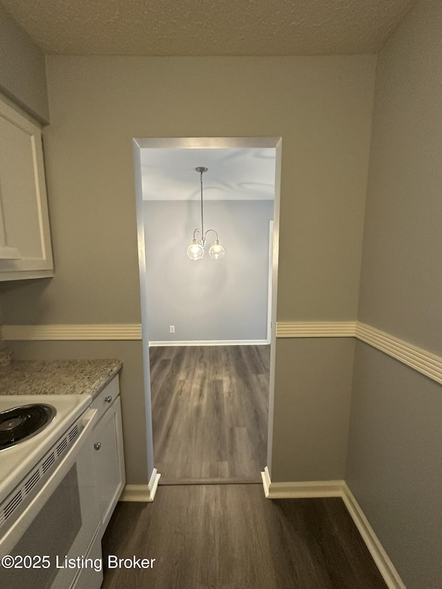 7070 Wildwood Cir Unit 154, Louisville, KY 40291 - kitchen featuring dark wood finished floors, white electric range, white cabinetry, and light stone countertops