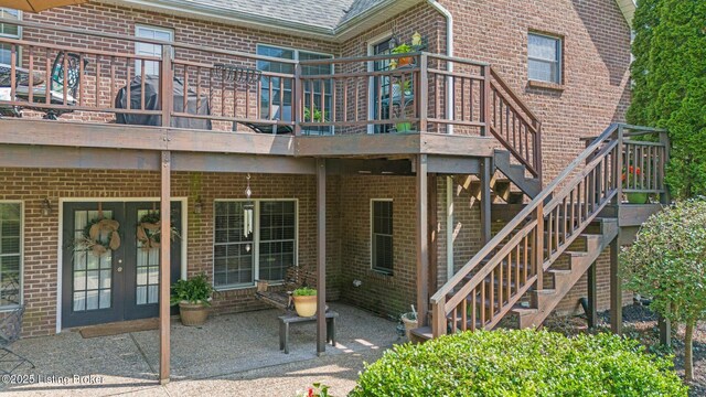 1119 Skyview Dr, Carrollton, KY 41008 - rear view of property featuring brick siding, a patio area, a wooden deck, and a shingled roof