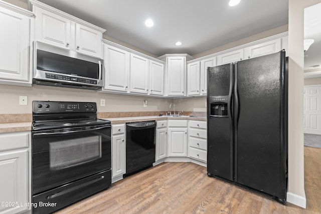 751 N Hite Ave Unit 2, Louisville, KY 40206 - kitchen with black appliances, white cabinetry, light countertops, light wood finished floors, and recessed lighting