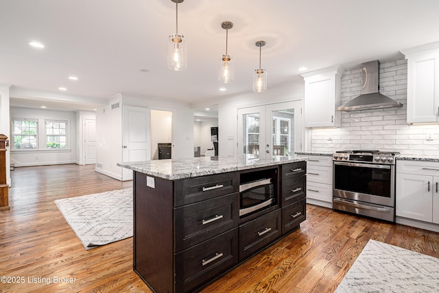 4022 Hycliffe Ave, Louisville, KY 40207 - kitchen featuring appliances with stainless steel finishes, wall chimney exhaust hood, white cabinets, recessed lighting, and wood finished floors