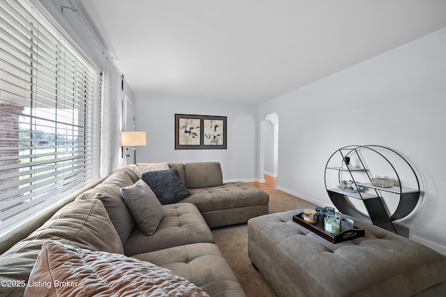 2301 Farnsley Rd, Louisville, KY 40216 - carpeted living room with healthy amount of natural light and arched walkways