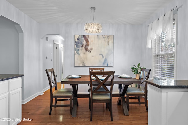 2301 Farnsley Rd, Louisville, KY 40216 - dining space featuring arched walkways, dark wood-style flooring, and a chandelier