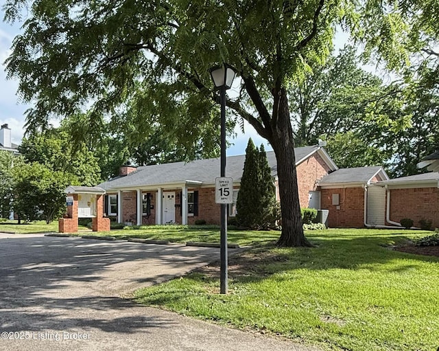 1305 Donard Park Ave, Louisville, KY 40218 - single story home with brick siding, a front yard, and a chimney