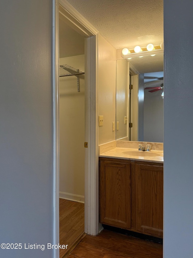 1305 Donard Park Ave, Louisville, KY 40218 - bathroom featuring wood finished floors, vanity, a textured ceiling, and ceiling fan