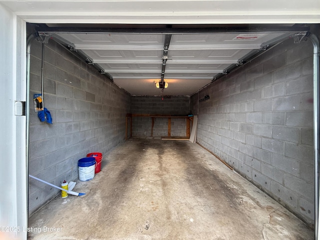 1305 Donard Park Ave, Louisville, KY 40218 - garage with a garage door opener and concrete block wall
