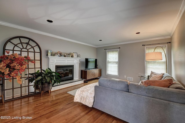 6011 Windsong Ct, Louisville, KY 40207 - living area featuring wood finished floors, crown molding, and a tiled fireplace