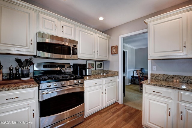 6011 Windsong Ct, Louisville, KY 40207 - kitchen with appliances with stainless steel finishes, white cabinetry, light wood-style floors, ornamental molding, and recessed lighting