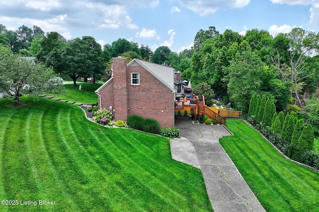 6011 Windsong Ct, Louisville, KY 40207 - view of side of home featuring brick siding, concrete driveway, a yard, and stairs