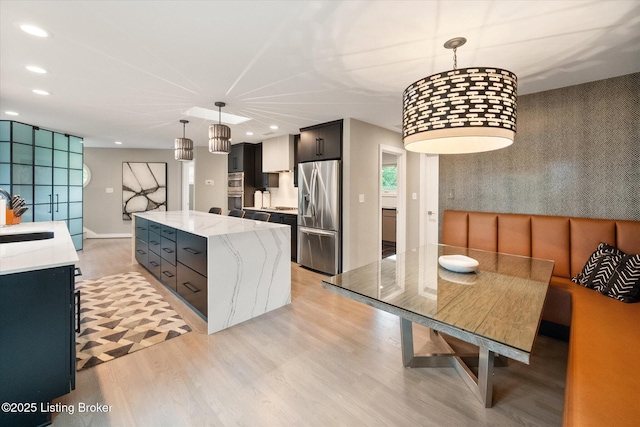 1430 Oakmont Ct, Shelbyville, KY 40065 - kitchen featuring stainless steel refrigerator with ice dispenser, a center island, light wood-style flooring, recessed lighting, and light stone counters