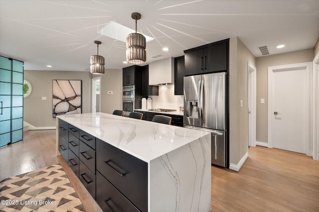 1430 Oakmont Ct, Shelbyville, KY 40065 - kitchen with stainless steel appliances, dark cabinets, light wood-style floors, pendant lighting, and a kitchen island