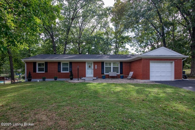 933 Lakeshore Pkwy, Brandenburg, KY 40108 - single story home with a garage, brick siding, driveway, and a front yard
