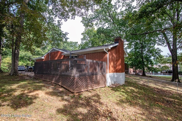 933 Lakeshore Pkwy, Brandenburg, KY 40108 - back of house with a chimney, brick siding, and a wooden deck