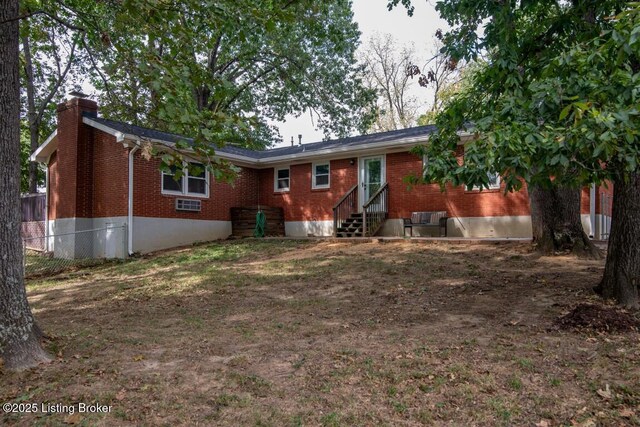 933 Lakeshore Pkwy, Brandenburg, KY 40108 - back of house with brick siding, entry steps, and a chimney